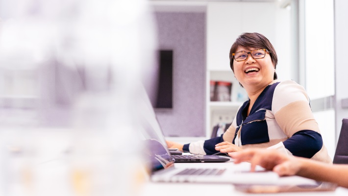 A women laughing and working