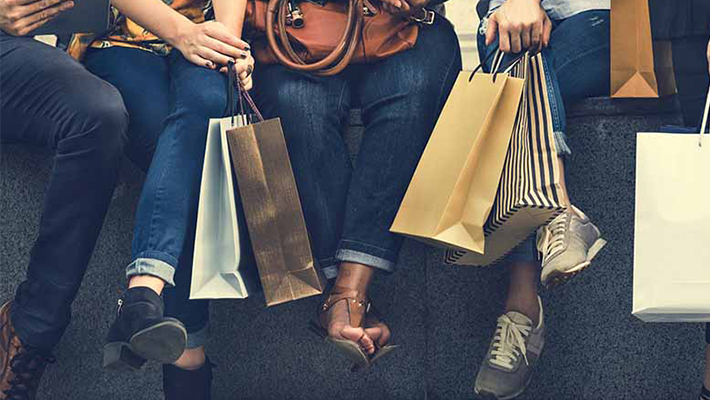 People sitting with shopping bags