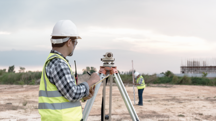 land surveyors working at construction site