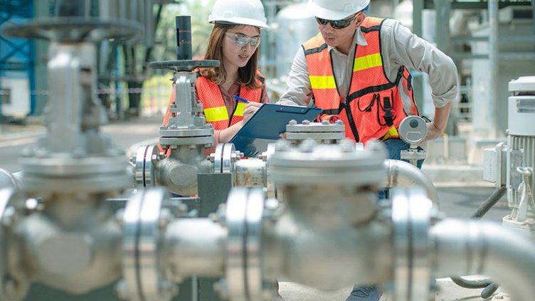 2 people working on machinery