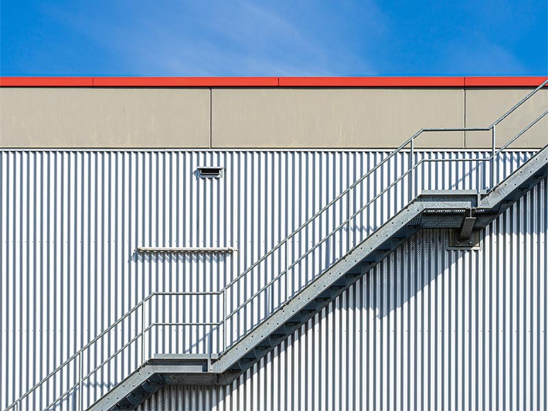 Metal stairs on side of warehouse