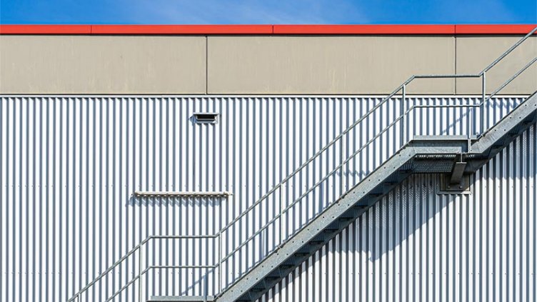 Metal stairs on side of warehouse