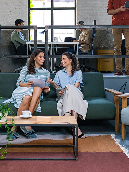 Two women sitting on a couch