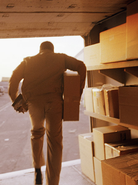 Worker getting packages from a truck