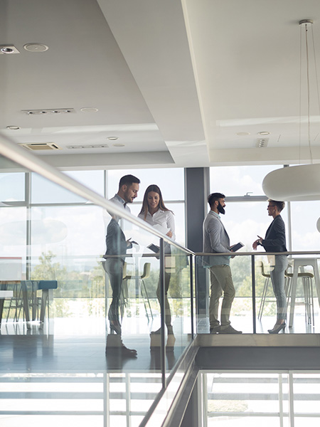 Group of business people walking and taking at stairs in an office building