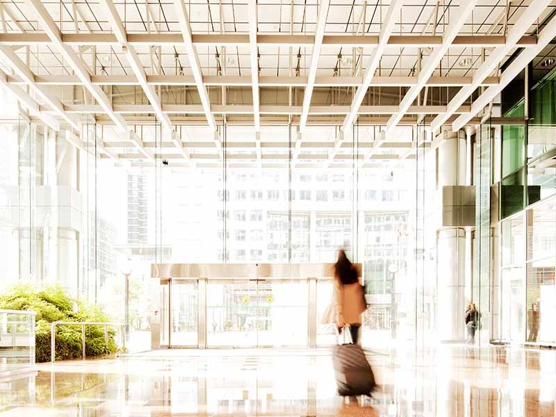 Woman with suitcase in lobby