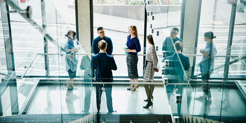 Business colleagues having informal meeting on office stairs