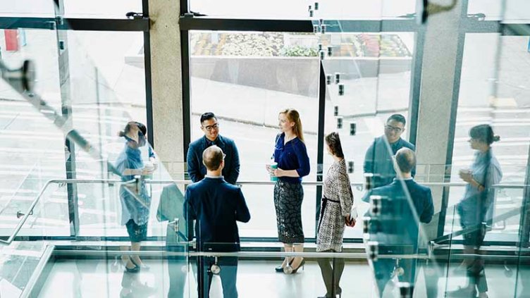 Business colleagues having informal meeting on office stairs