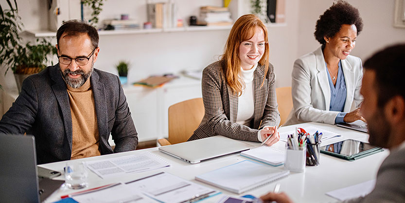 Team of corporate professionals having discussion in a meeting in conference room.