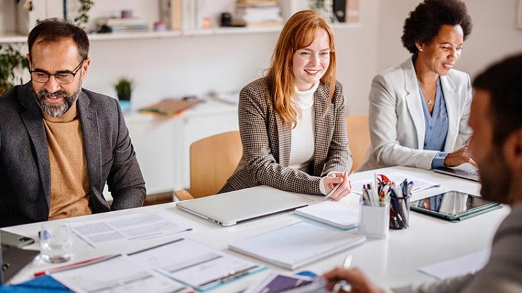 Team of corporate professionals having discussion in a meeting in conference room.