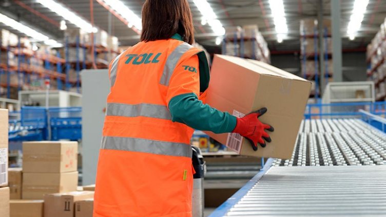 A worker picking up a parcel