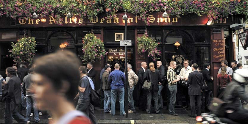 People gathered around one of the british pub