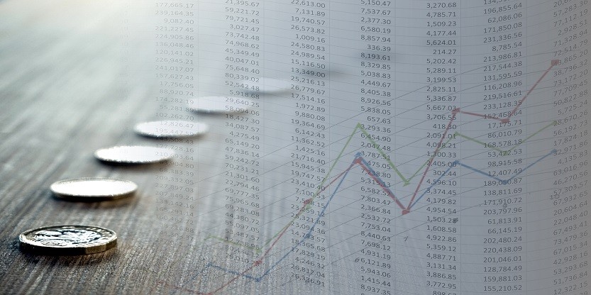 Coins with coloured stock chart and spreadsheet having numbers flowing left to right in flag style