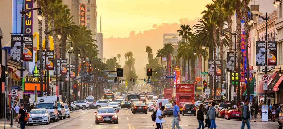 View of people walking and cars running on the street in Los Angeles