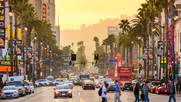 View of people walking and cars running on the street in Los Angeles