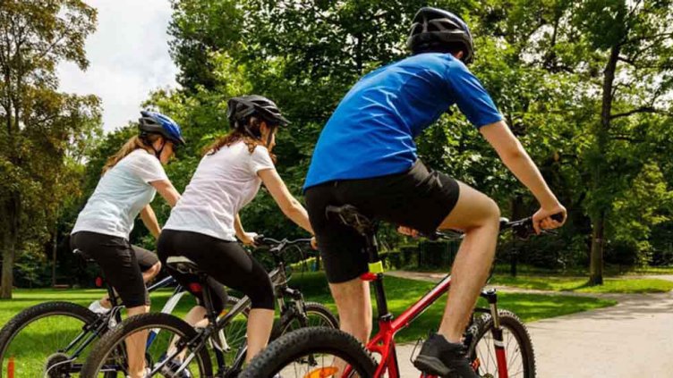 Three children riding their bicycle