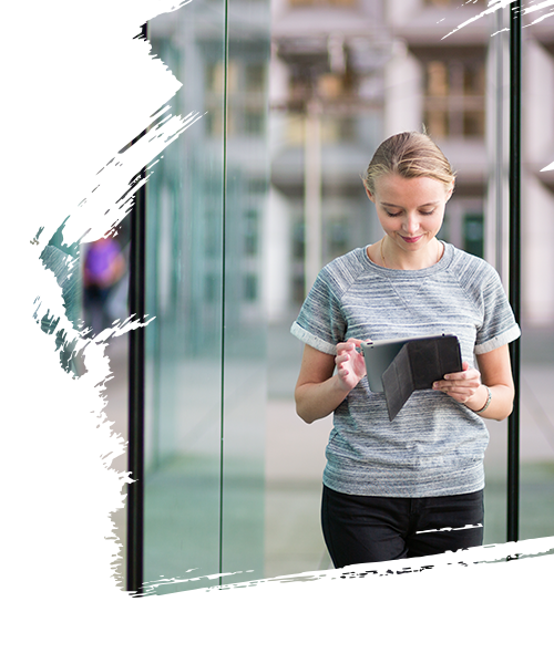 A lady walking while using her tablet