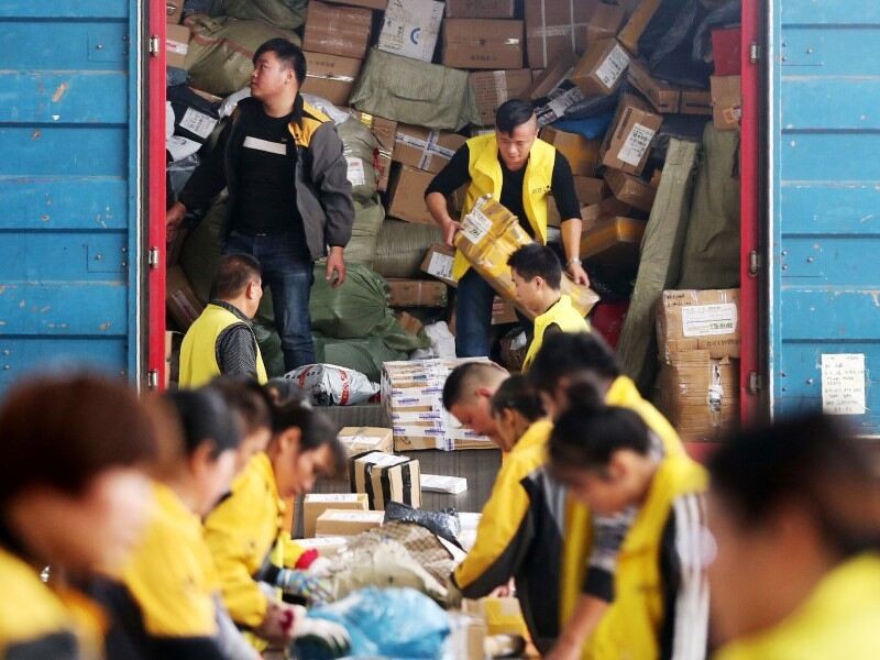 Workers unloading the consignment from the loading truck