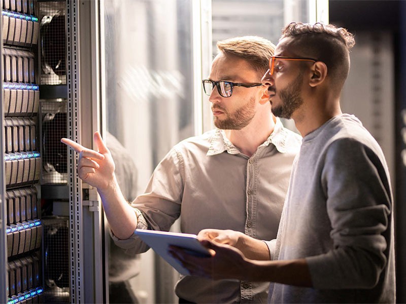 Two people in a server room
