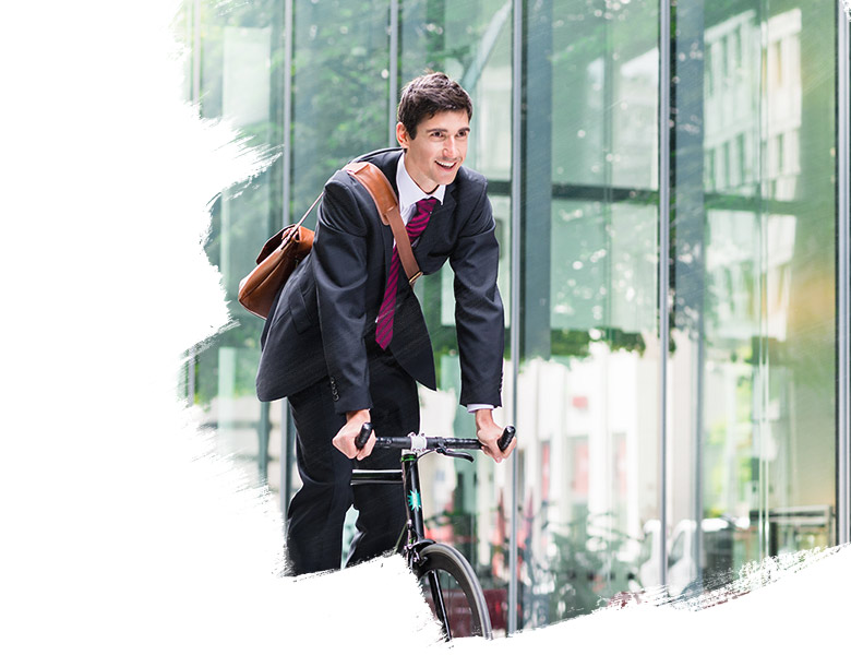 Cheerful young employee riding an utility bicycle in Berlin