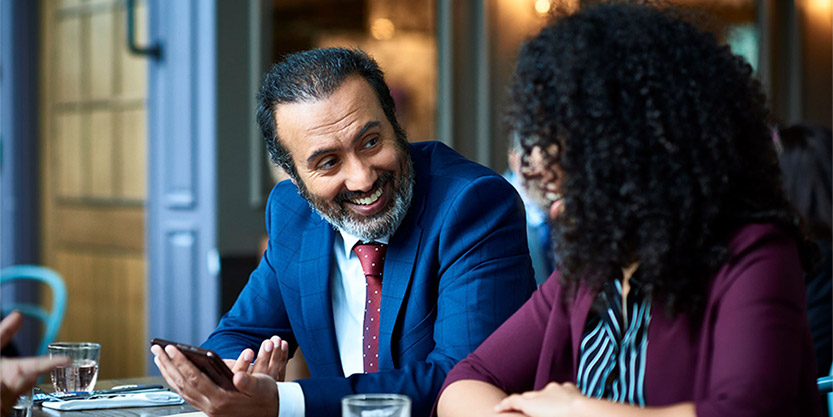 Two business people sitting at a table talking