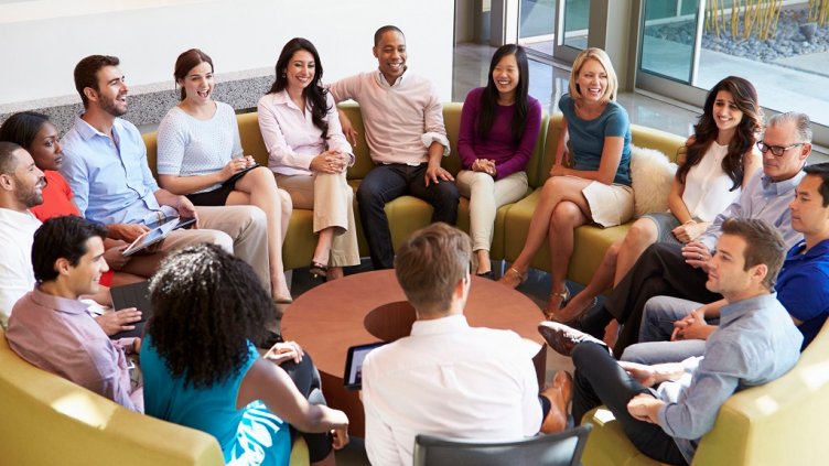 31047519 - multi-cultural office staff sitting having meeting together