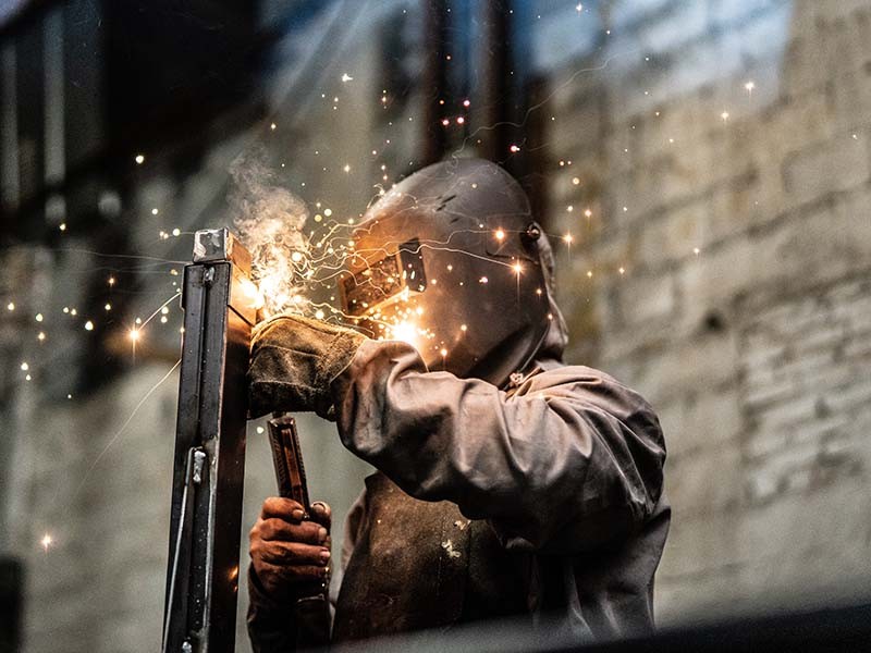 Worker welding the steel