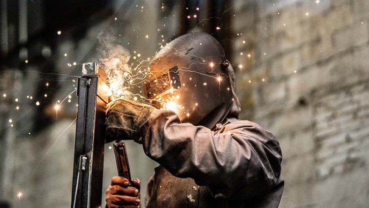 Worker welding the steel