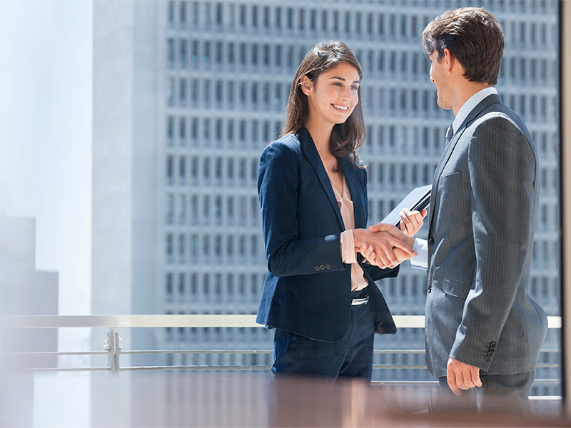 Two professionals greeting each other before starting their work