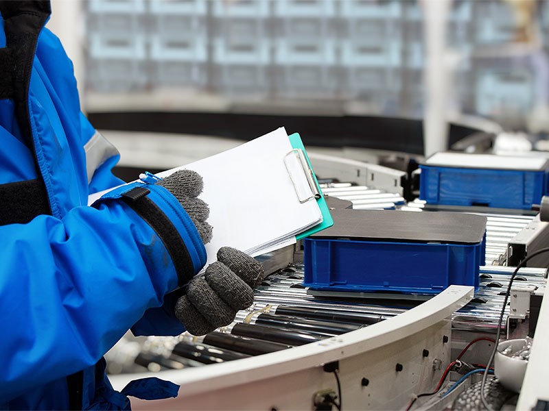 A man managing the data of vaccines in a cold storage