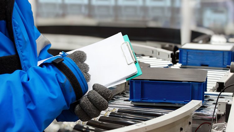 A man managing the data of vaccines in a cold storage