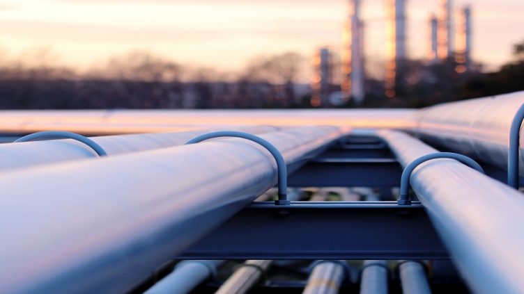 steel long pipe system in crude oil factory during sunset