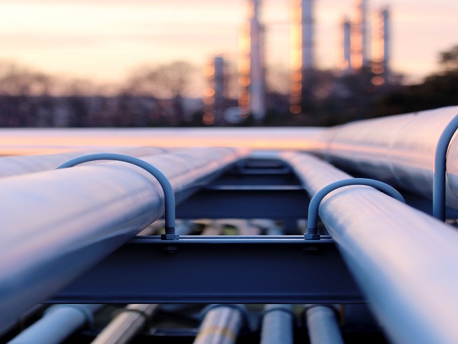 steel long pipe system in crude oil factory during sunset