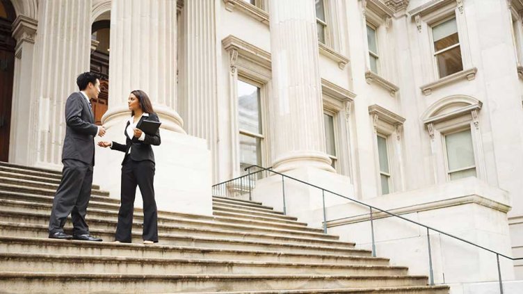Picture of two real estate employees talking on the stairs