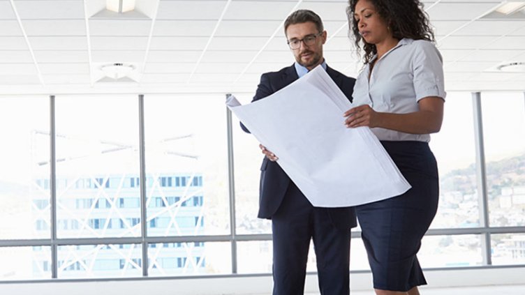 man and woman look over floorplan