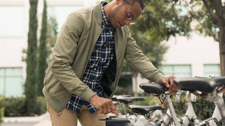 Businessman using a rideshare bicycle