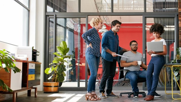 Coworkers meet in eco-friendly workspace