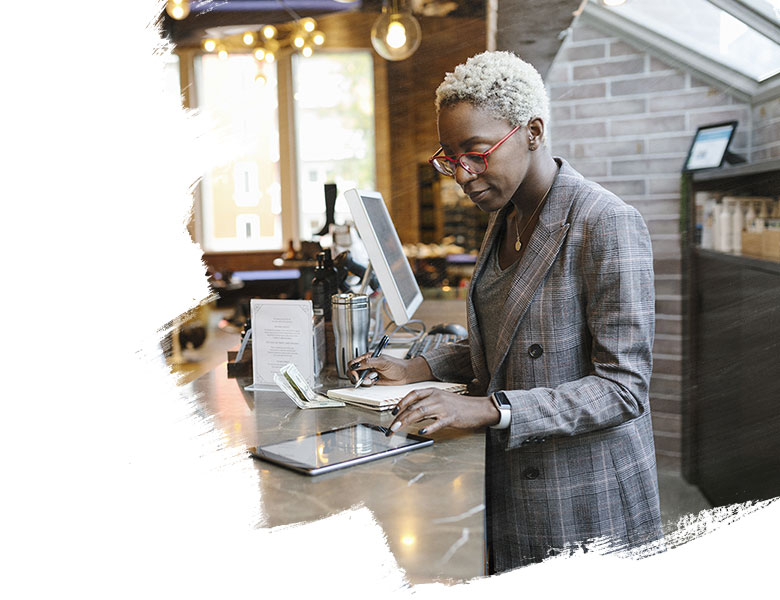 Woman taking notes from tablet