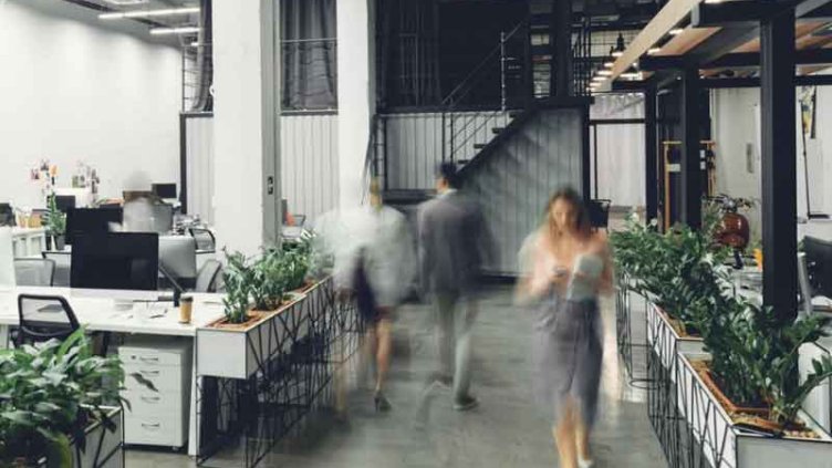 Employees walking inside a modern office space