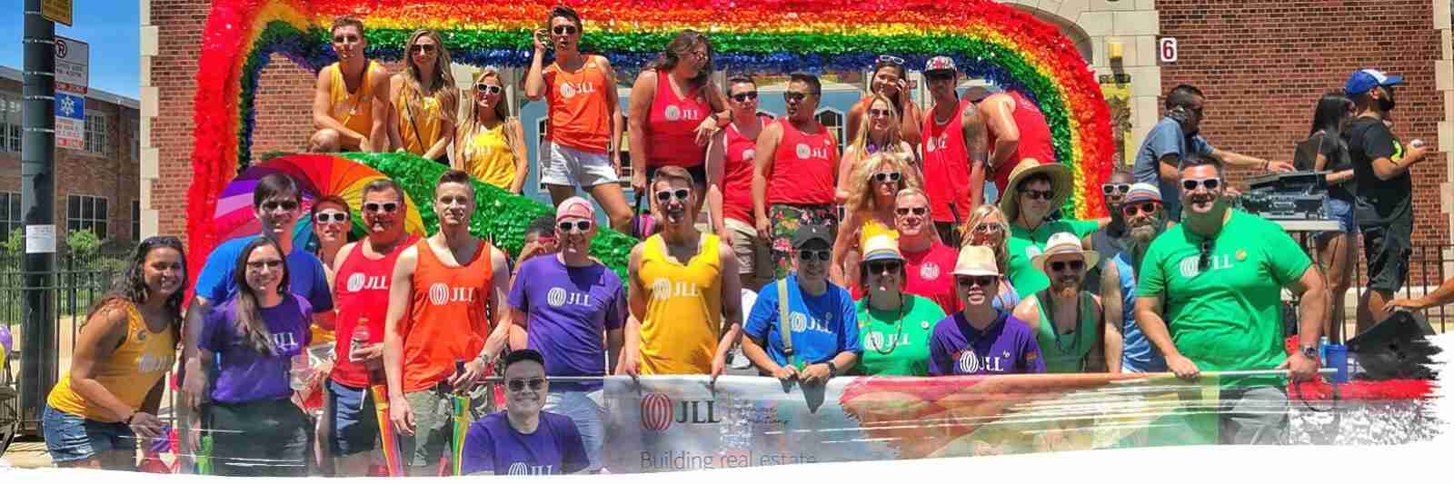 Group picture of JLL employees in a local event holding a banner