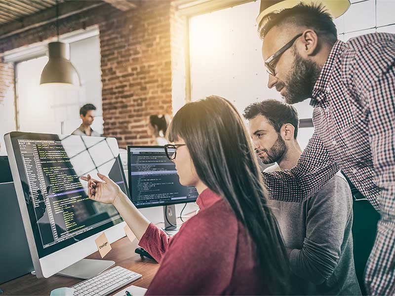 Team discussing code written by a colleague