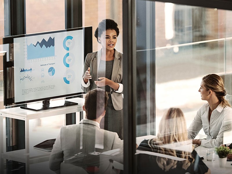 A small team gathered around a whiteboard in an office